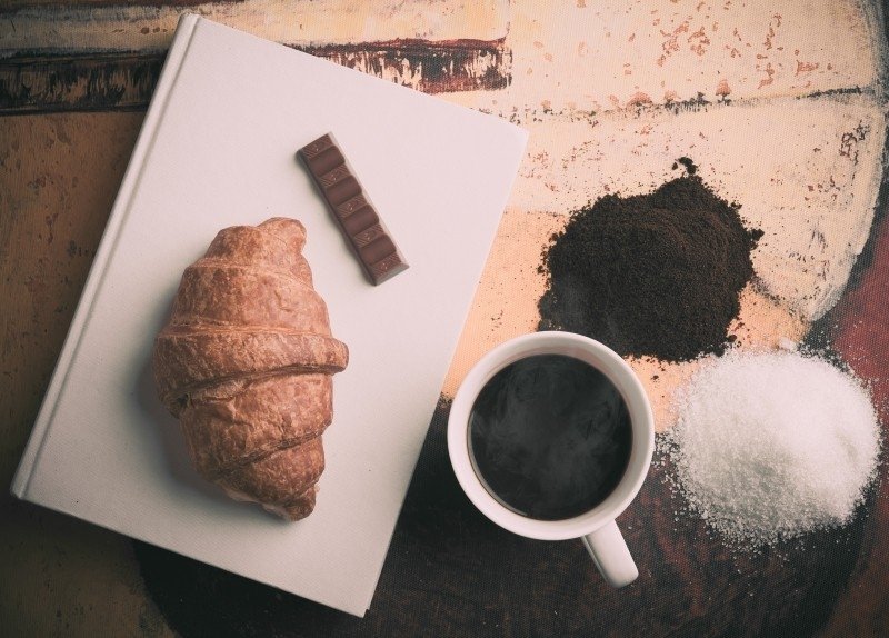 aerial-view-of-croissant-chocolate-piece-and-coffee-cup-min.jpg