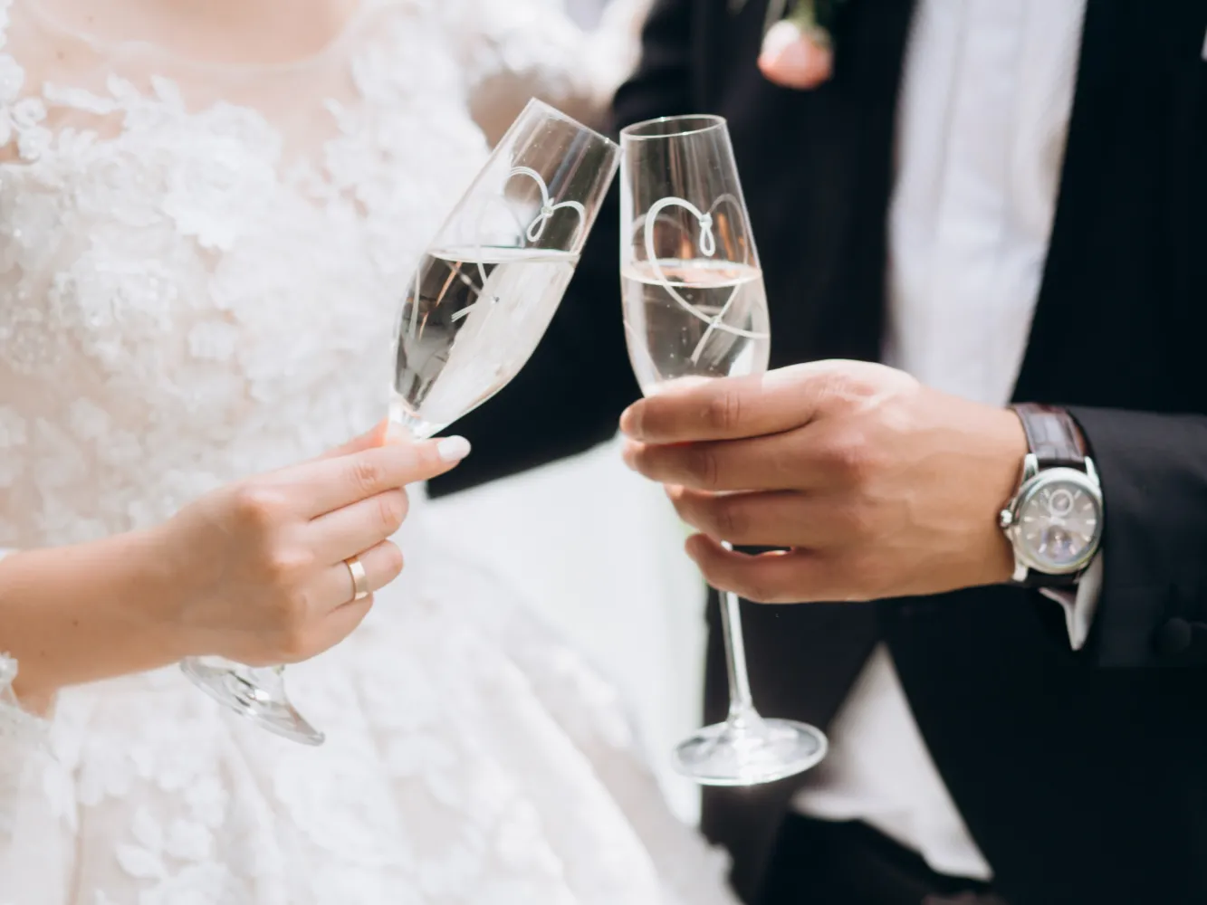 groom-with-bride-are-knocking-glasses-with-champagne