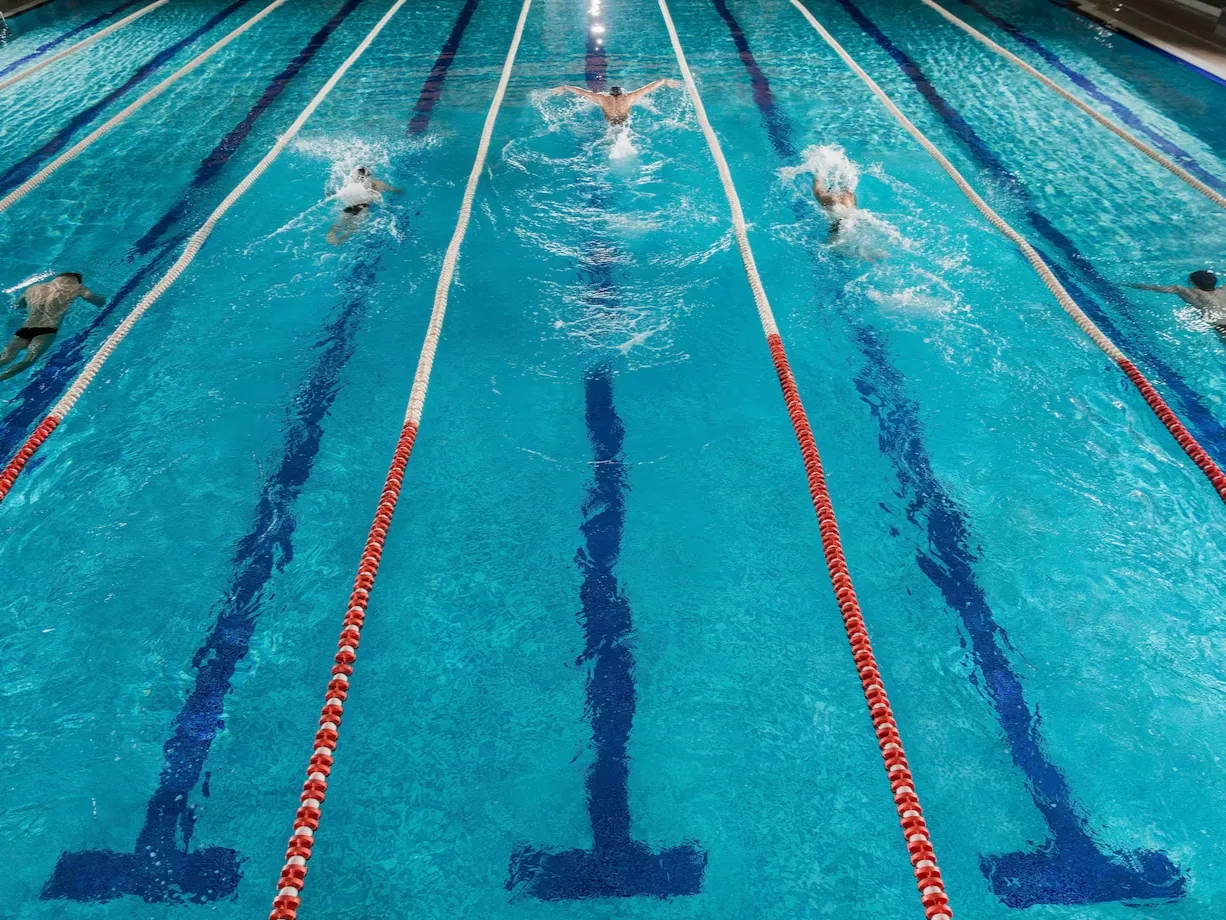 five-swimmers-racing-against-each-other-swiming-pool_171337-7818