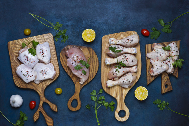 raw-chicken-meat-fillet-thigh-wings-legs-with-herbs-spices-lemon-garlic-dark-blue-background-top-view-2831-1068.jpg