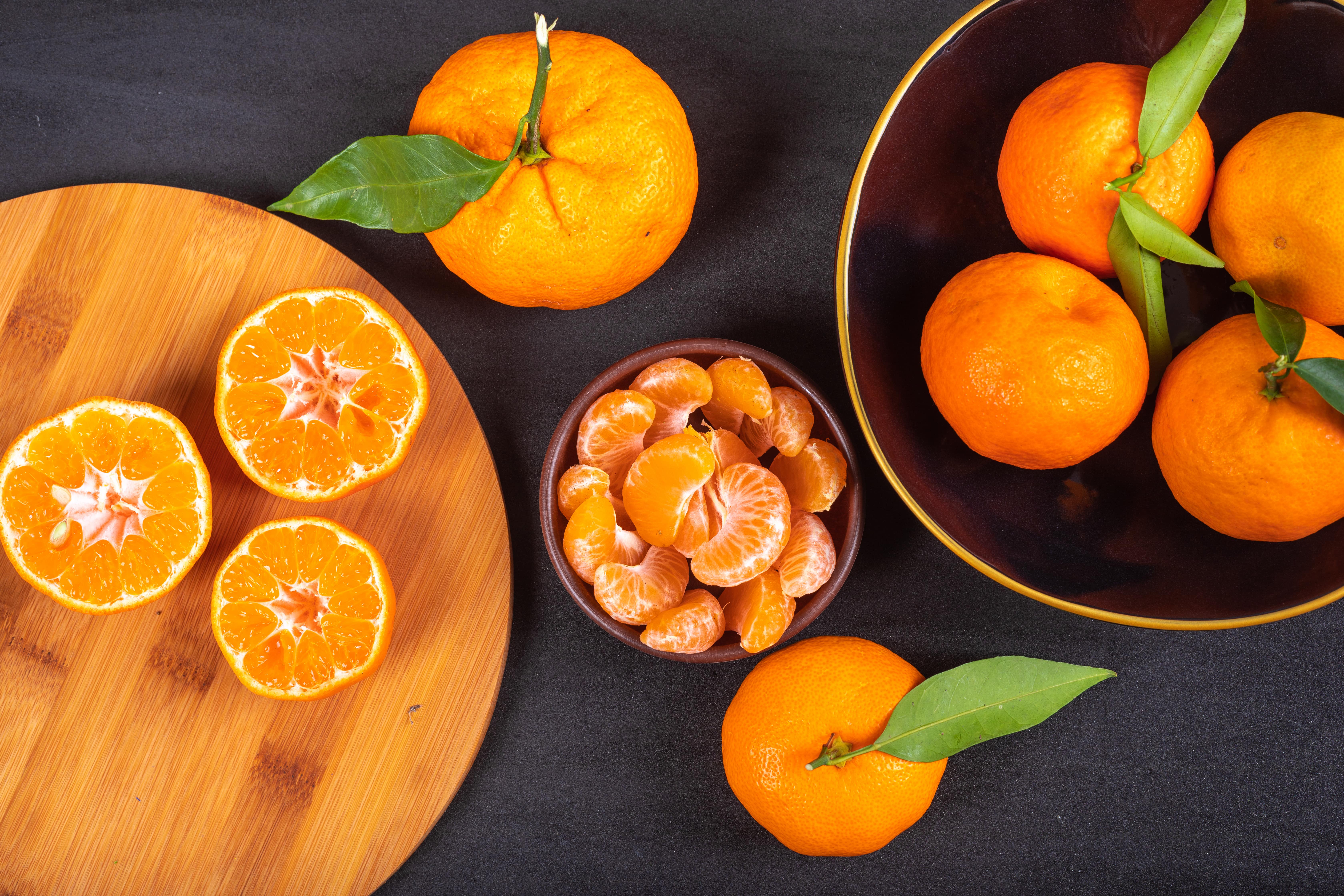 fresh-mandarins-wood-cutting-board-plate-top-view-min.jpg